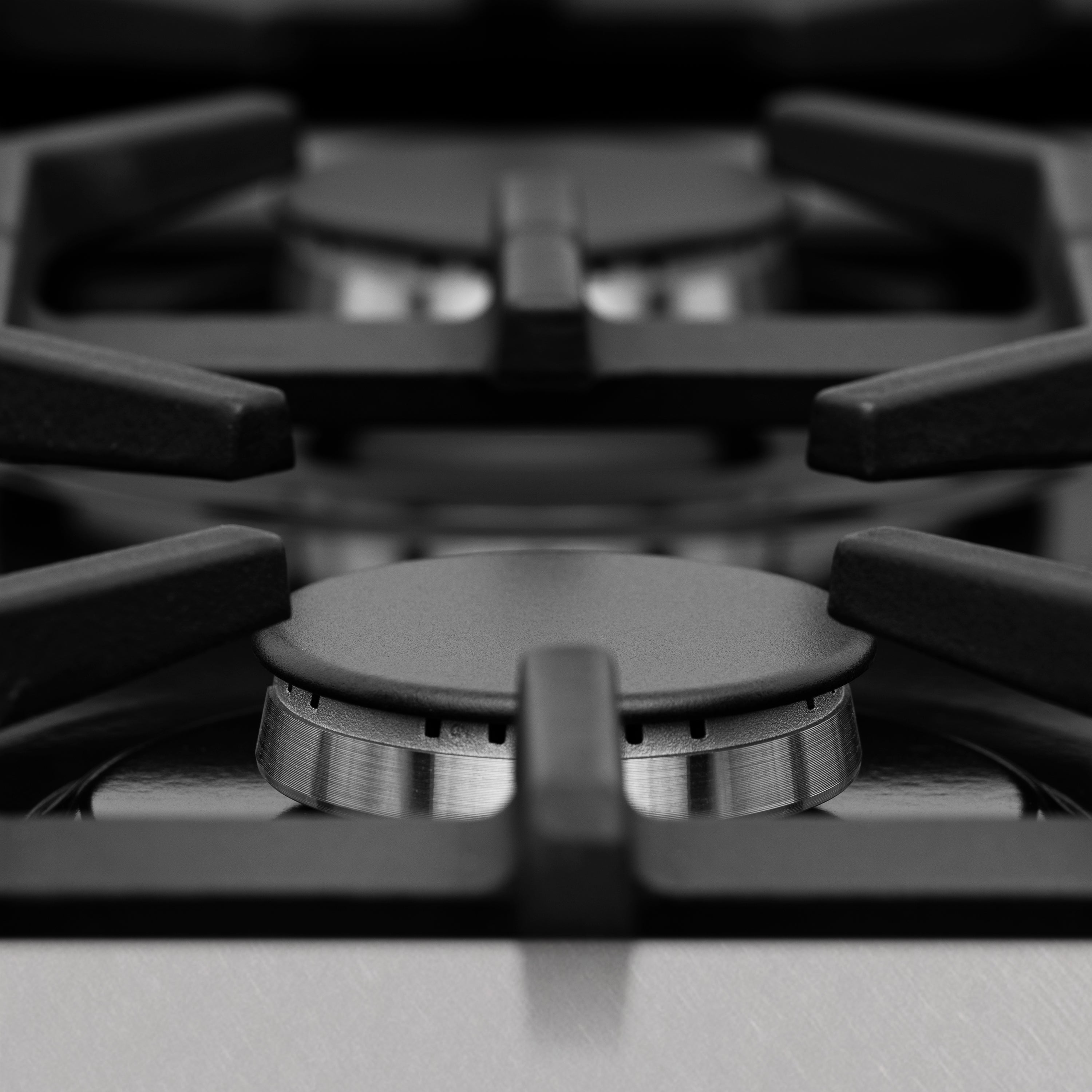 Close-up of stainless cooktop burner control knob on a dual fuel range