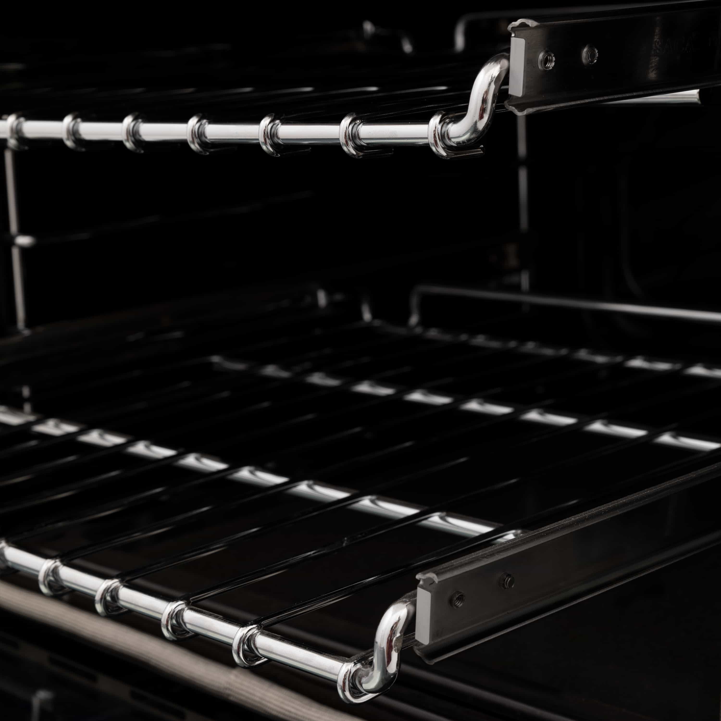 Stainless dual-fuel range cooktop with metal burner grates and control knobs