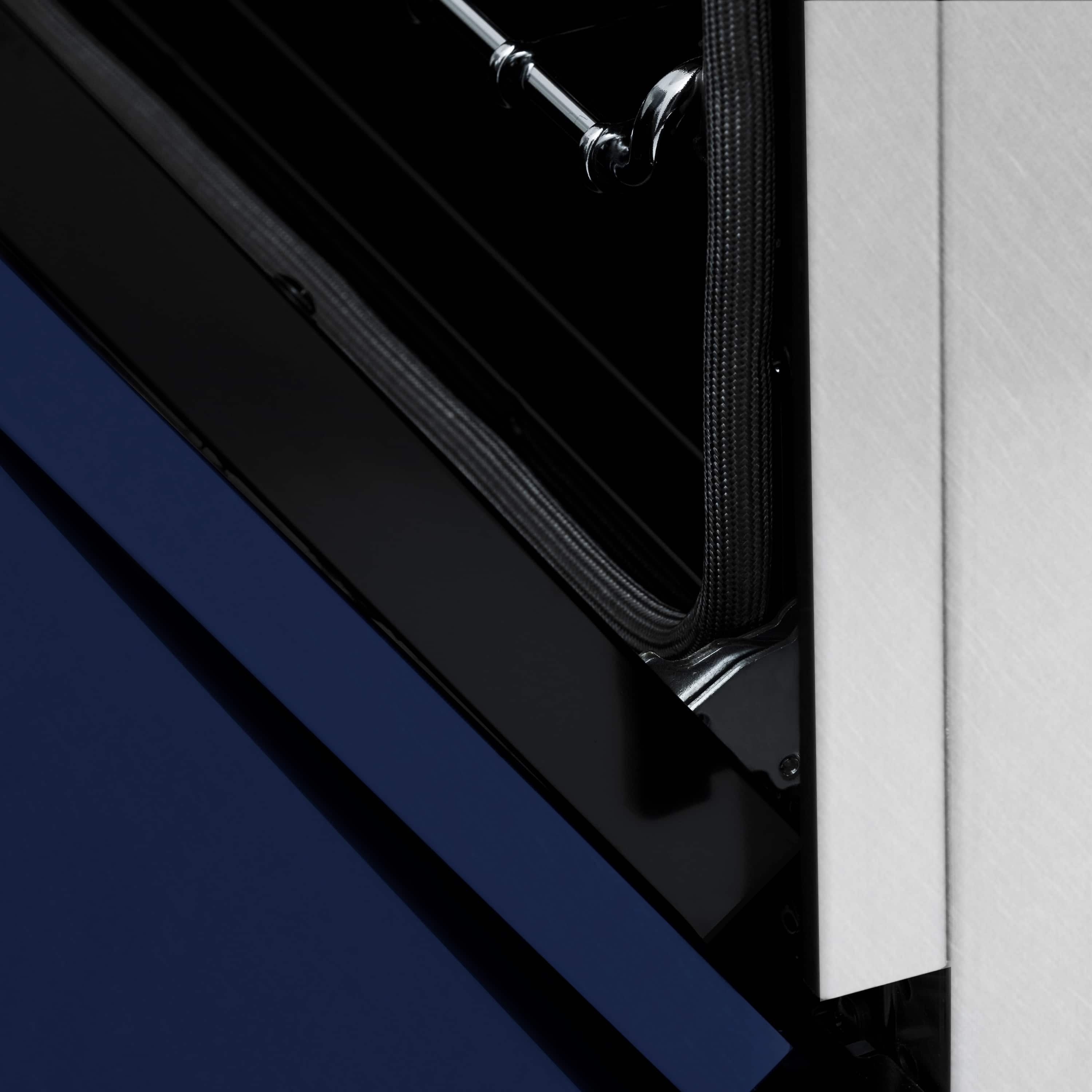 Blue oven door edge and stainless hinge area on a dual fuel range