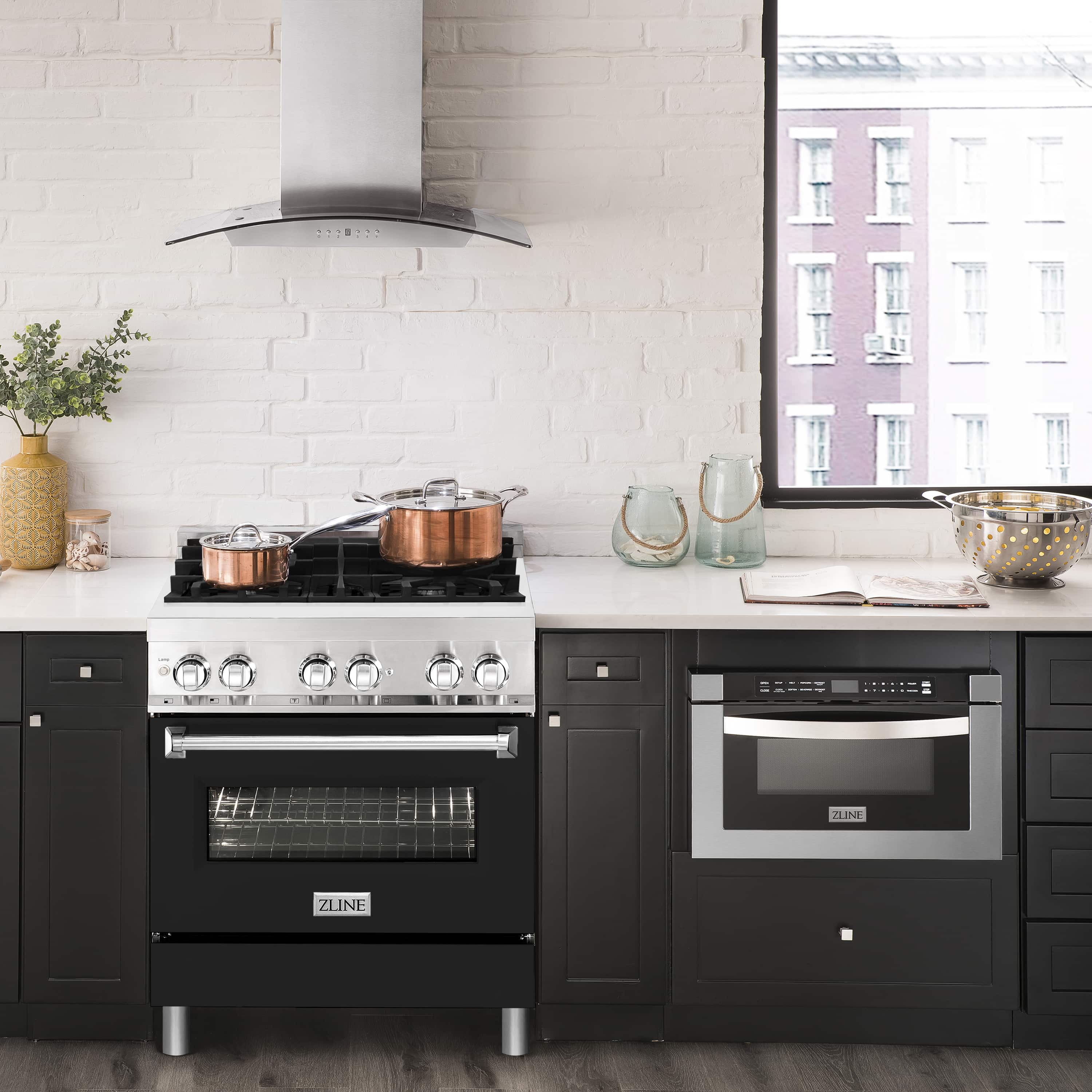 Dual fuel range in kitchen setting with black oven door and stainless cooktop