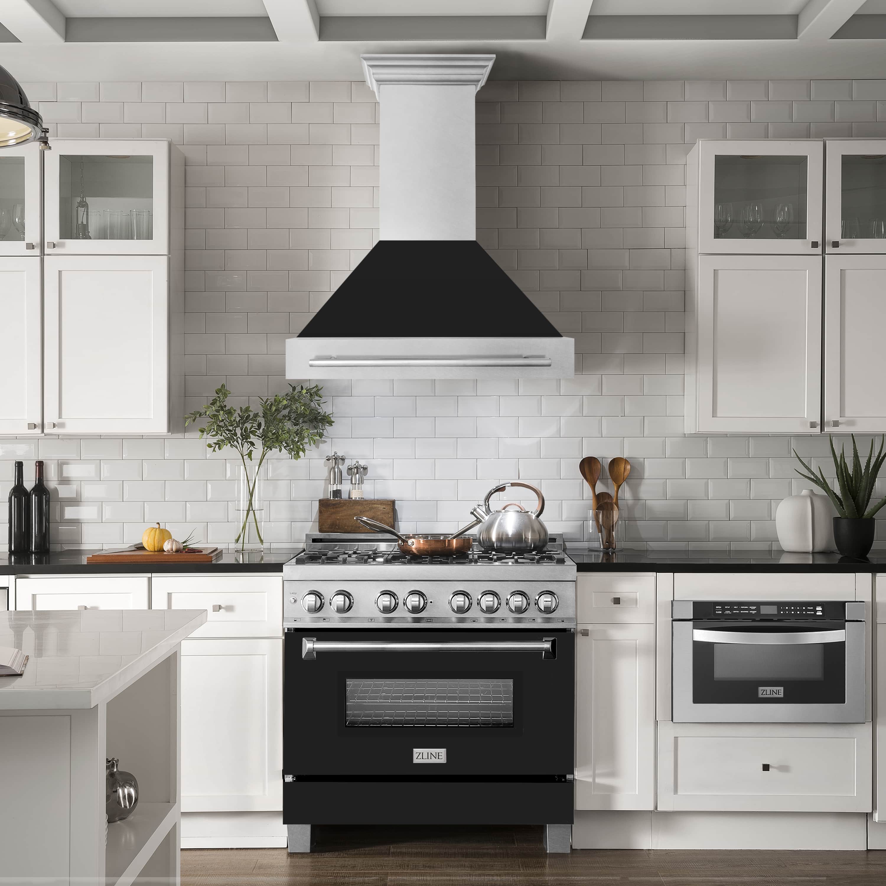 Wall mount range hood centered above stove, satin stainless with black matte chimney