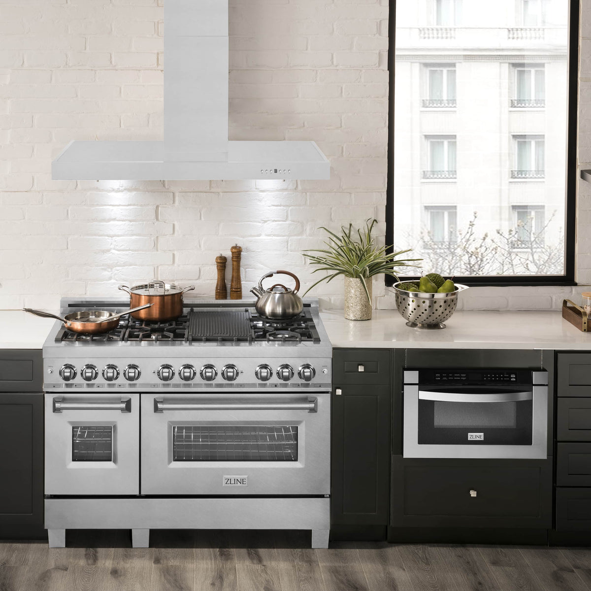 Stainless steel range hood installed above a gas cooktop in a modern kitchen
