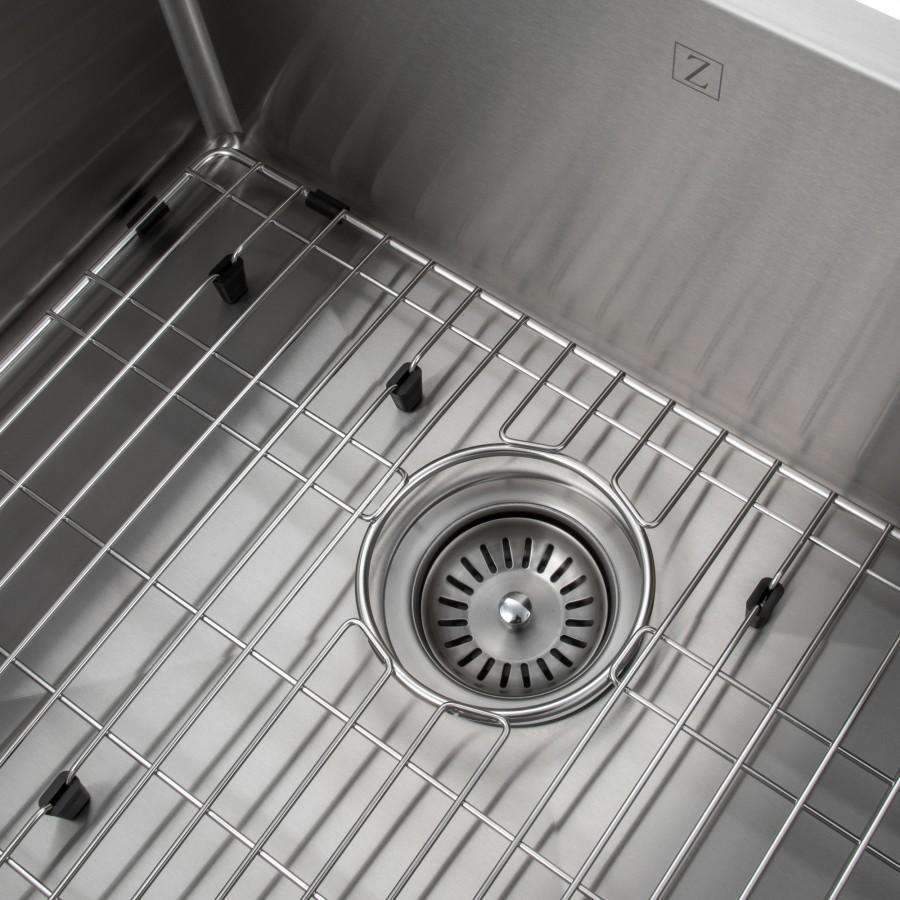 Stainless steel sink drain and bottom grid close-up with black support pegs