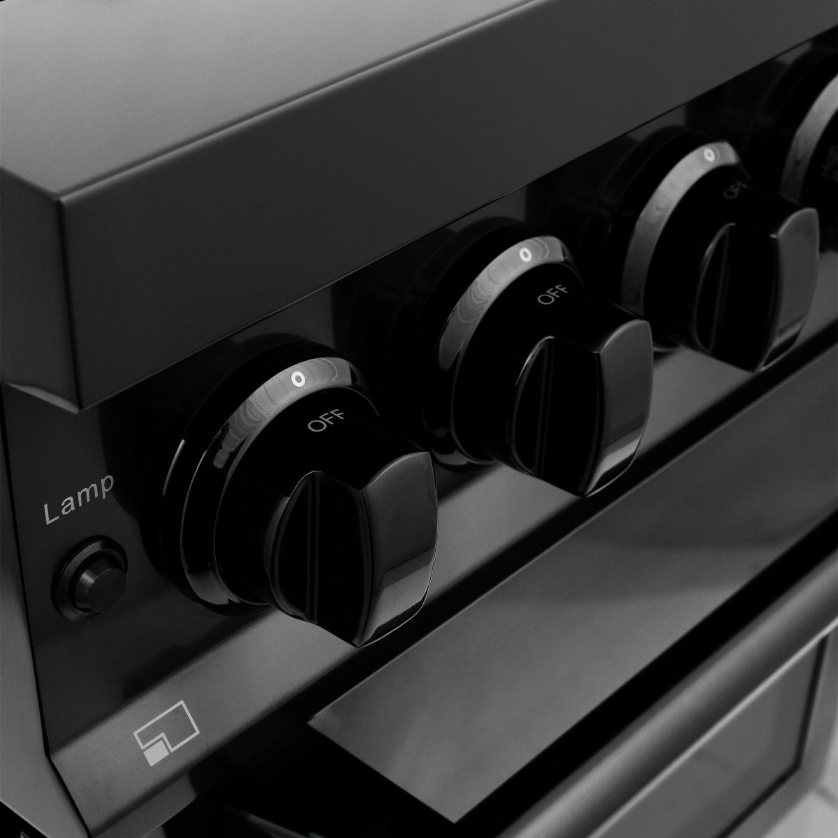 Black stainless oven control knobs on a dual fuel range with off indicators
