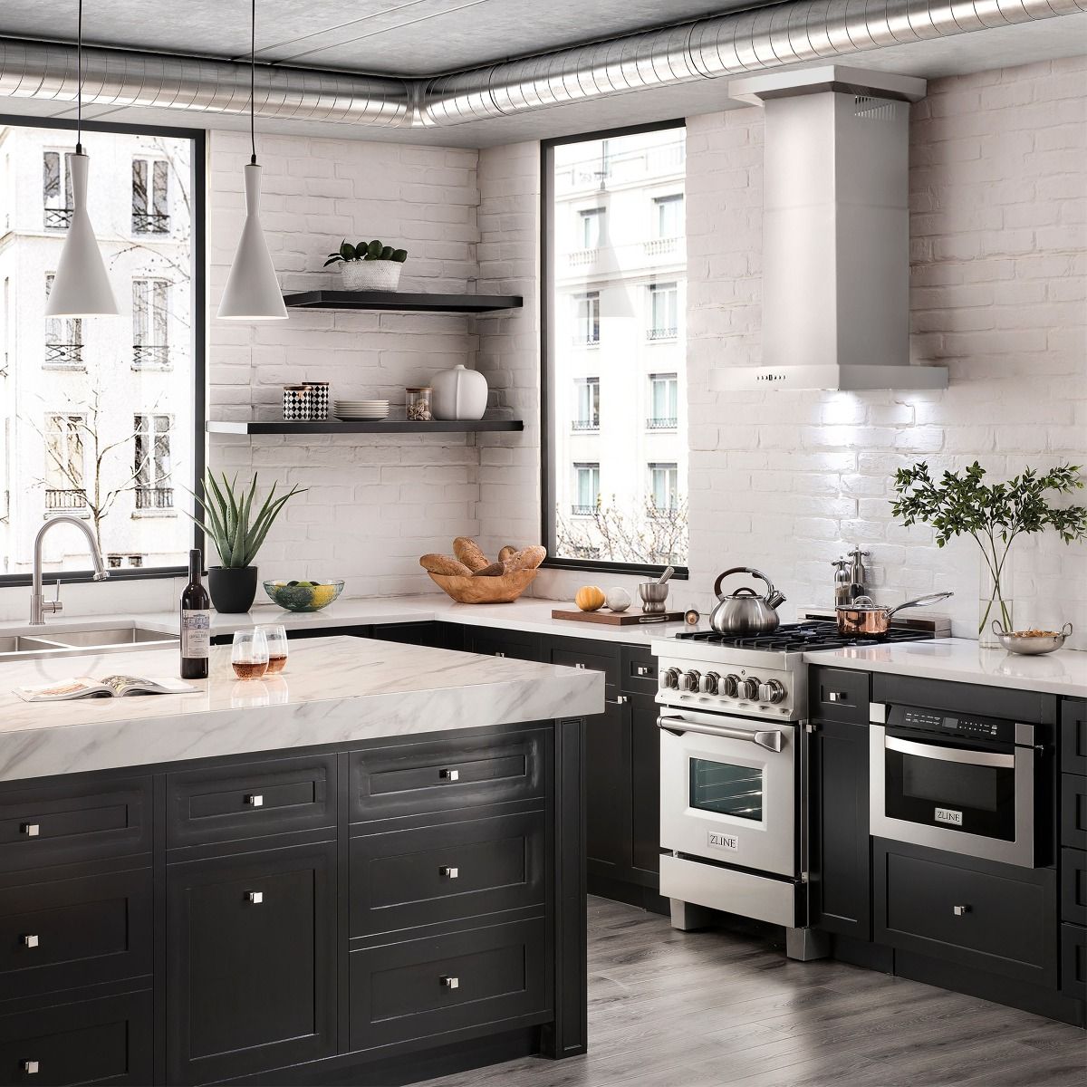 Stainless steel wall mount range hood with chimney and vent canopy over cooktop