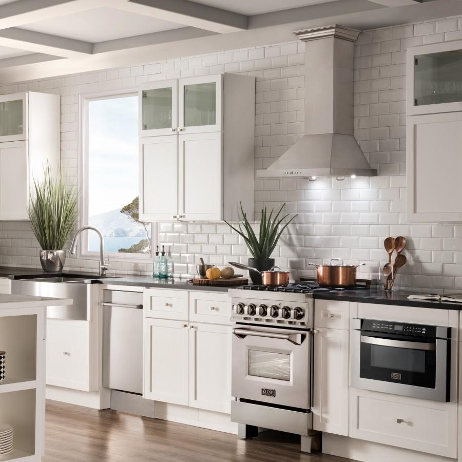 Light gray wall-mount range hood over a kitchen cooktop