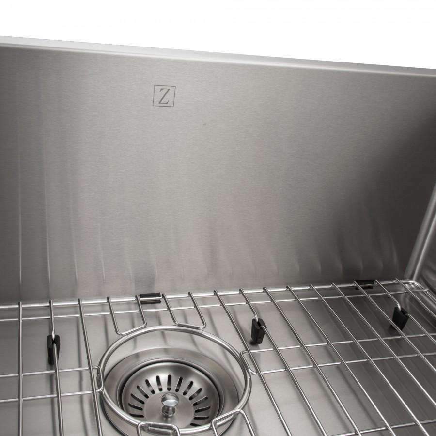 Stainless steel sink interior with round drain strainer and bottom grid support bars