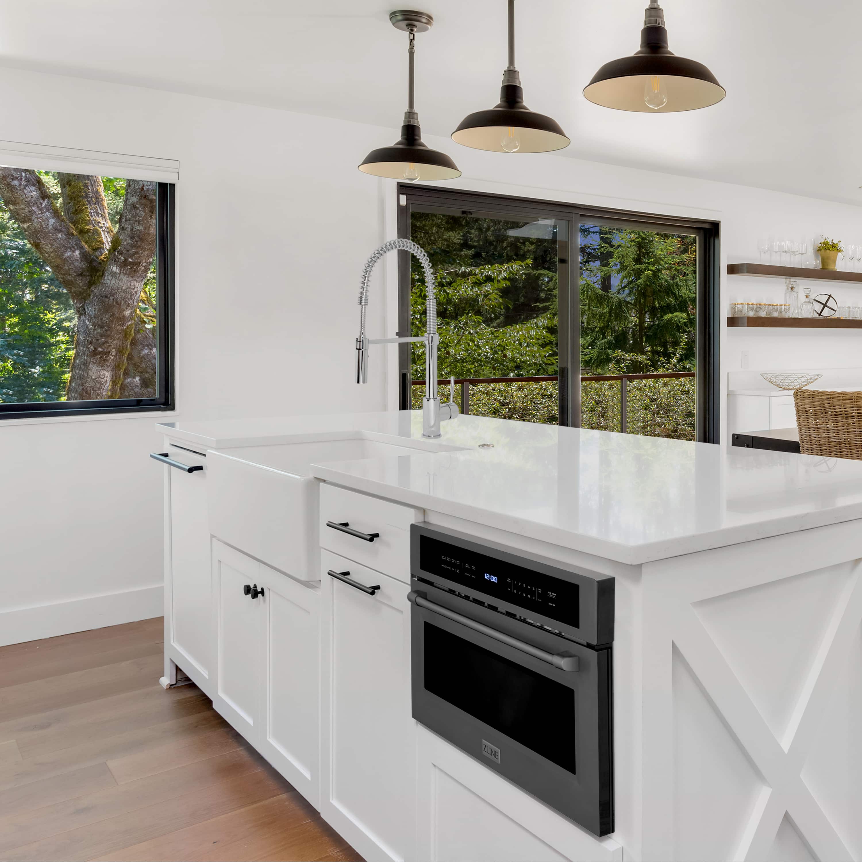 Black stainless steel built-in convection microwave oven installed in white kitchen cabinetry
