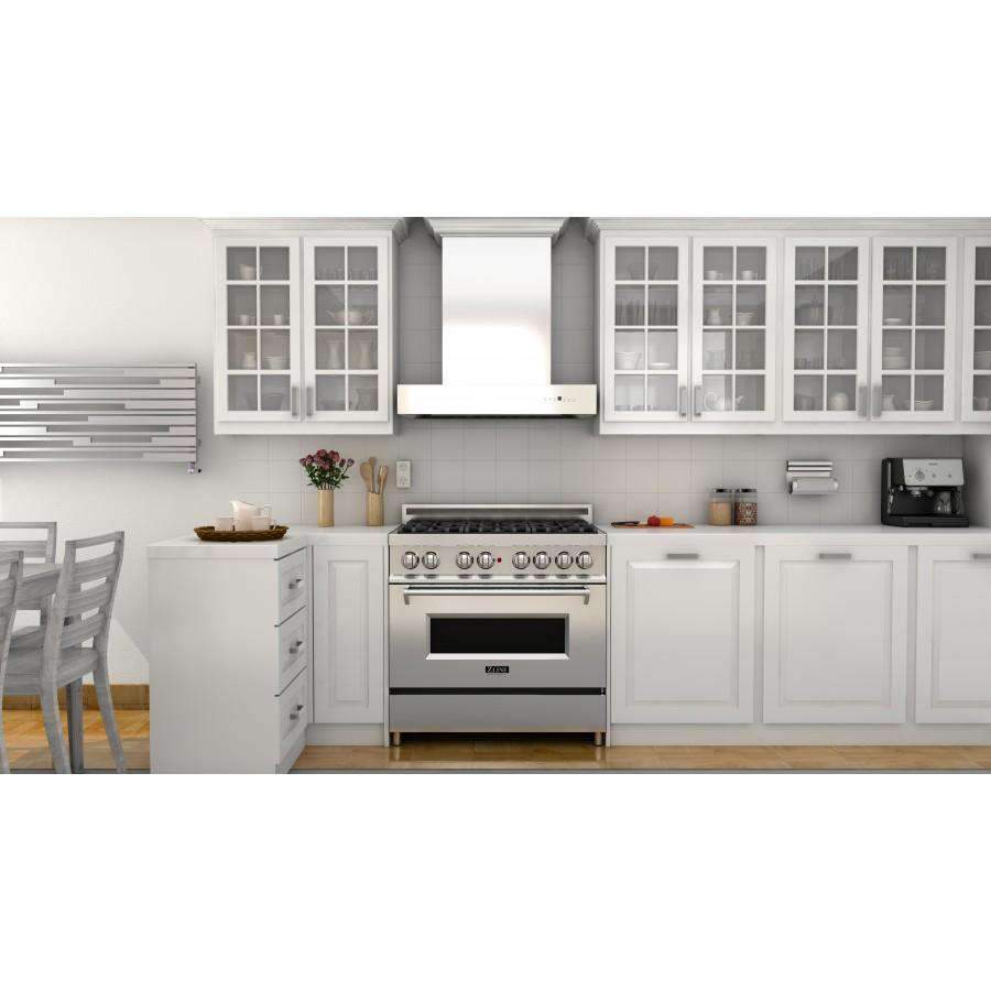Stainless steel wall-mount range hood mounted over a gas cooktop