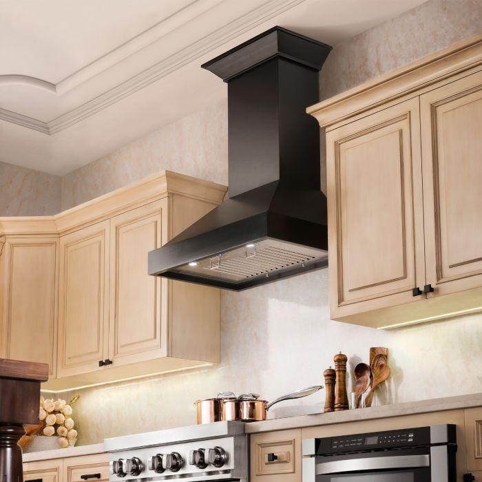 Black chimney range hood with crown molding and stainless baffle filter panel