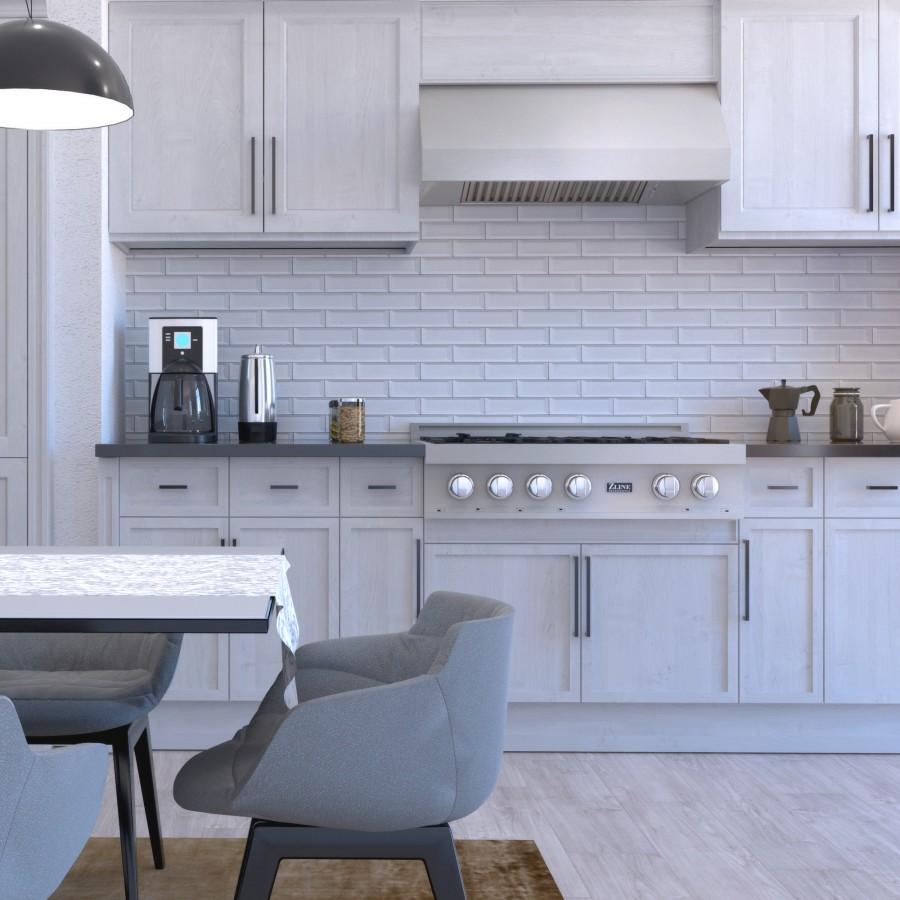 Under-cabinet stainless range hood with vent grille and round control buttons over stove