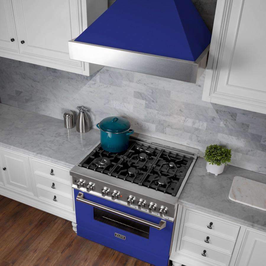 Wall-mount range hood with stainless flue and blue matte shell above the gas cooktop
