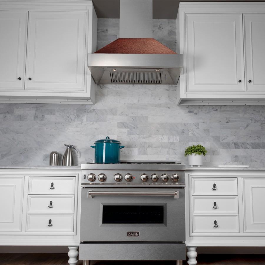 Wall mount range hood above cooktop; stainless steel chimney with copper baffle
