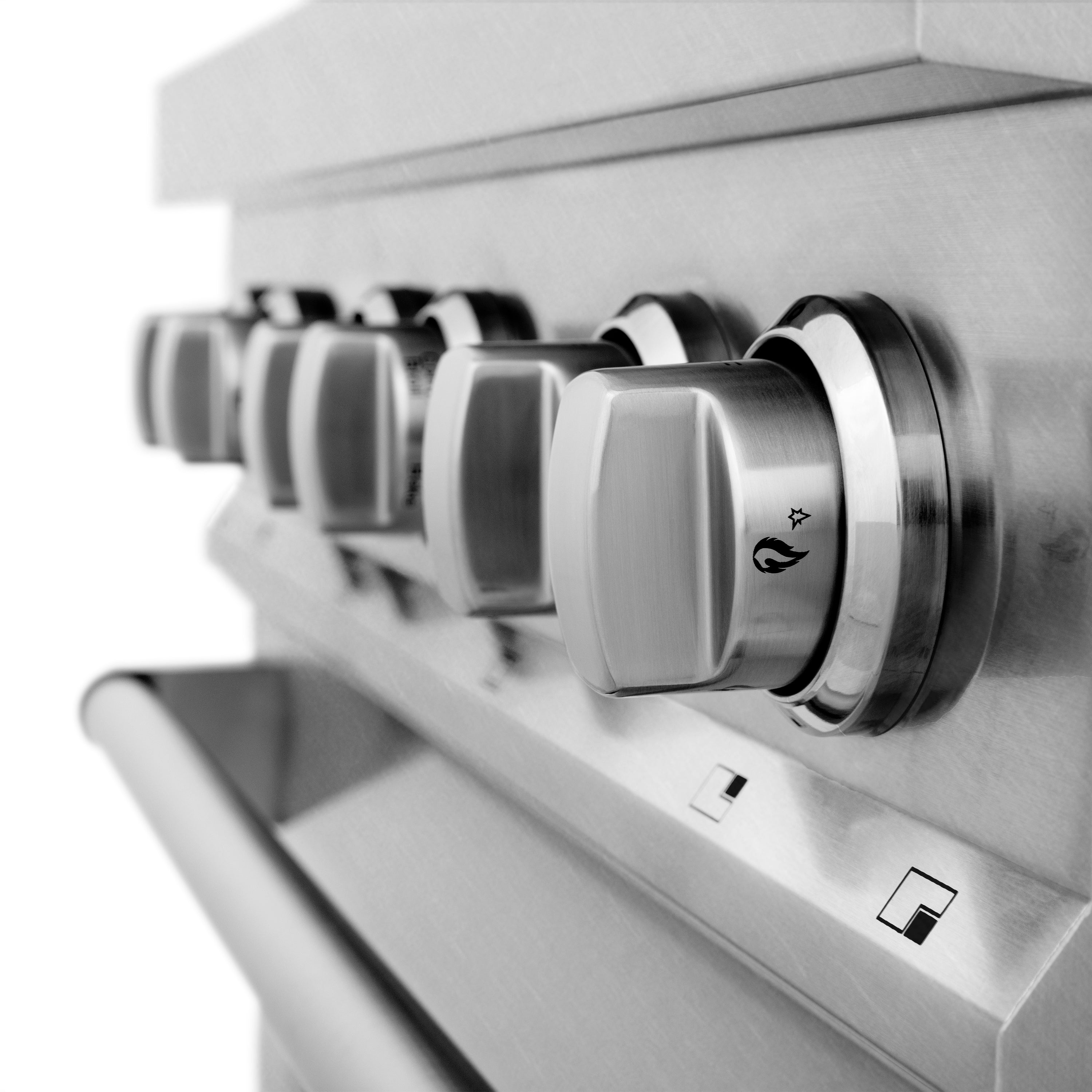 Stainless control panel with multiple round burner knobs and black accents