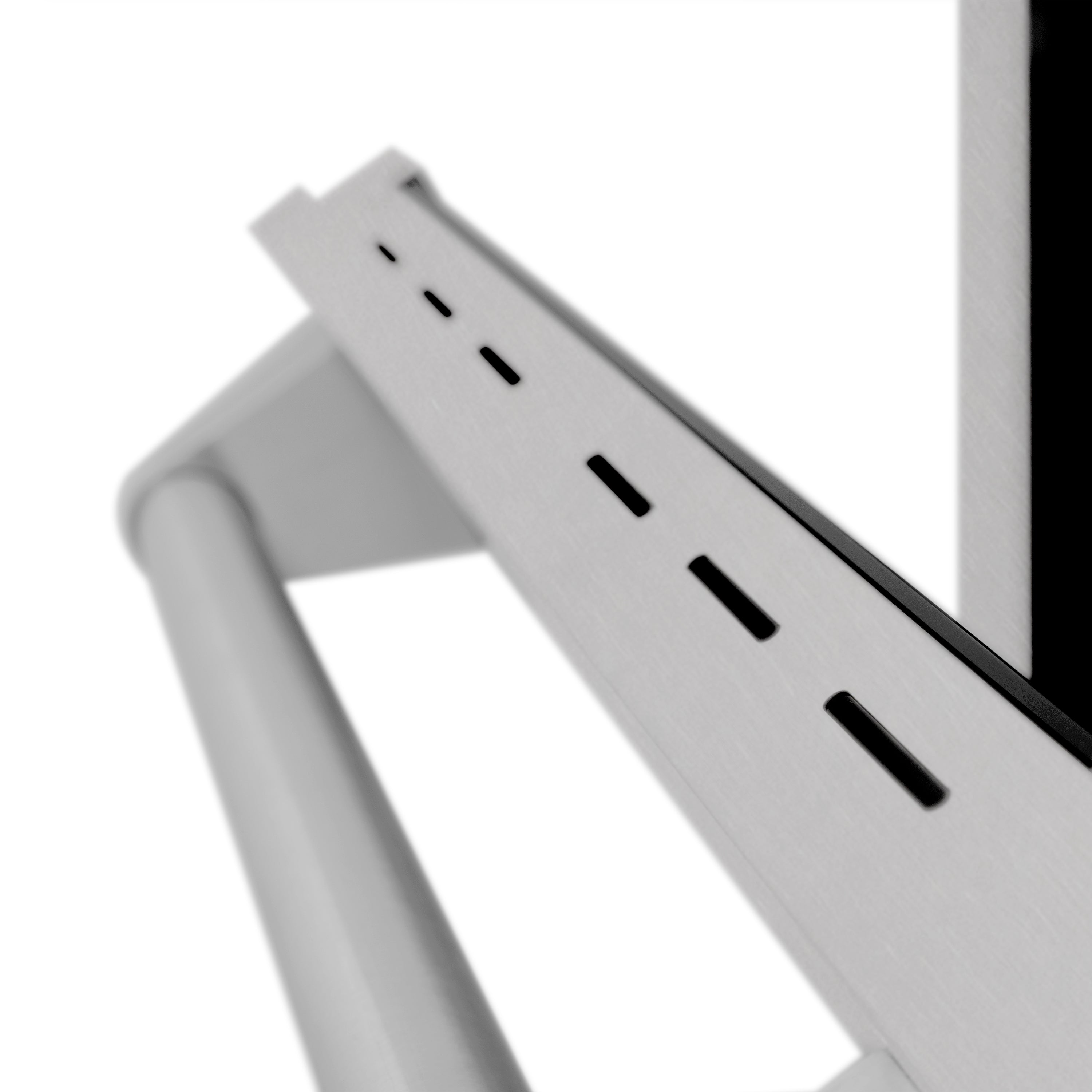 Stainless range vent trim with narrow slot openings along the edge