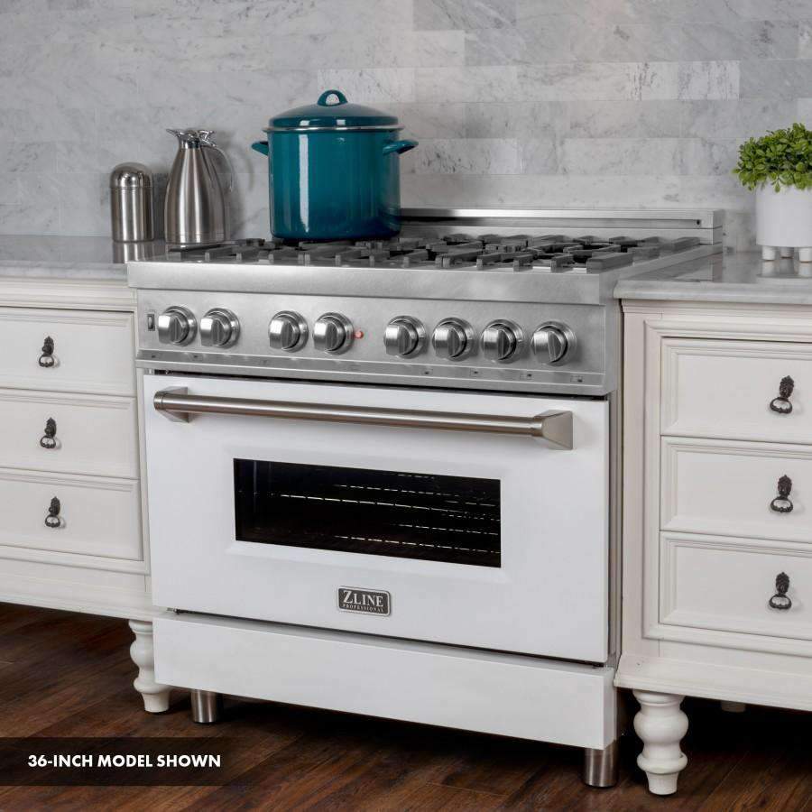 Dual fuel range with stainless cooktop grates, white matte oven door, round control knobs.