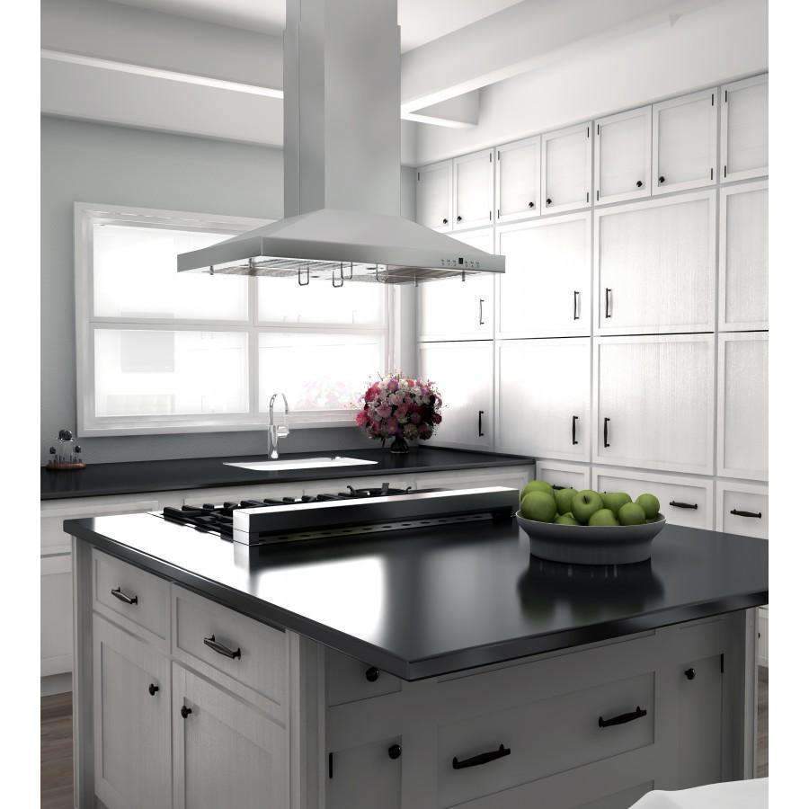 Stainless steel island range hood above a black cooktop in a bright kitchen