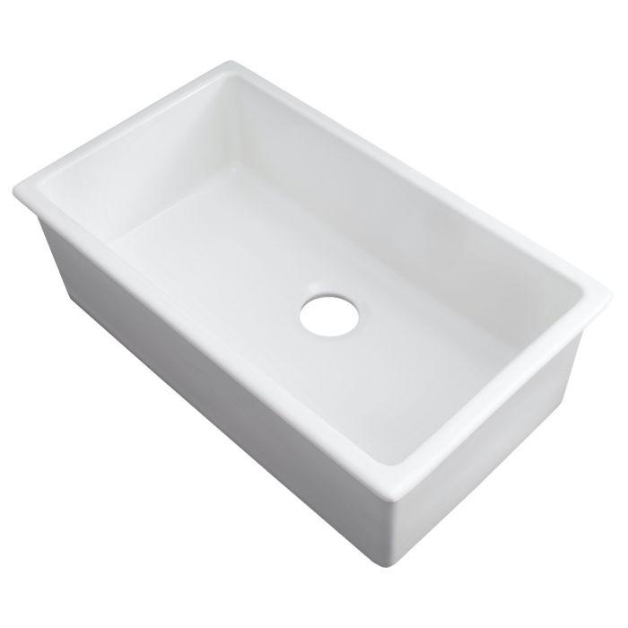 White fireclay single-bowl sink with angled view and round drain hole