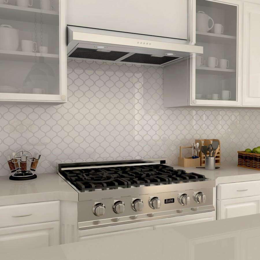 Stainless steel under-cabinet range hood above cooktop with visible vent controls.