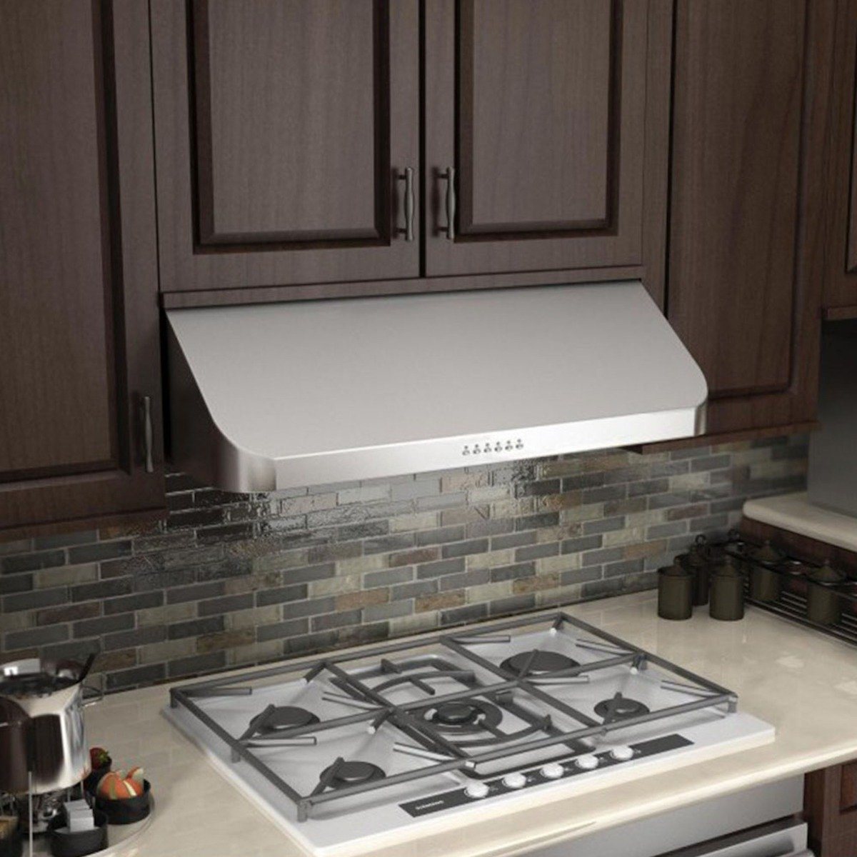 Stainless steel under-cabinet range hood with vent slots above cooktop