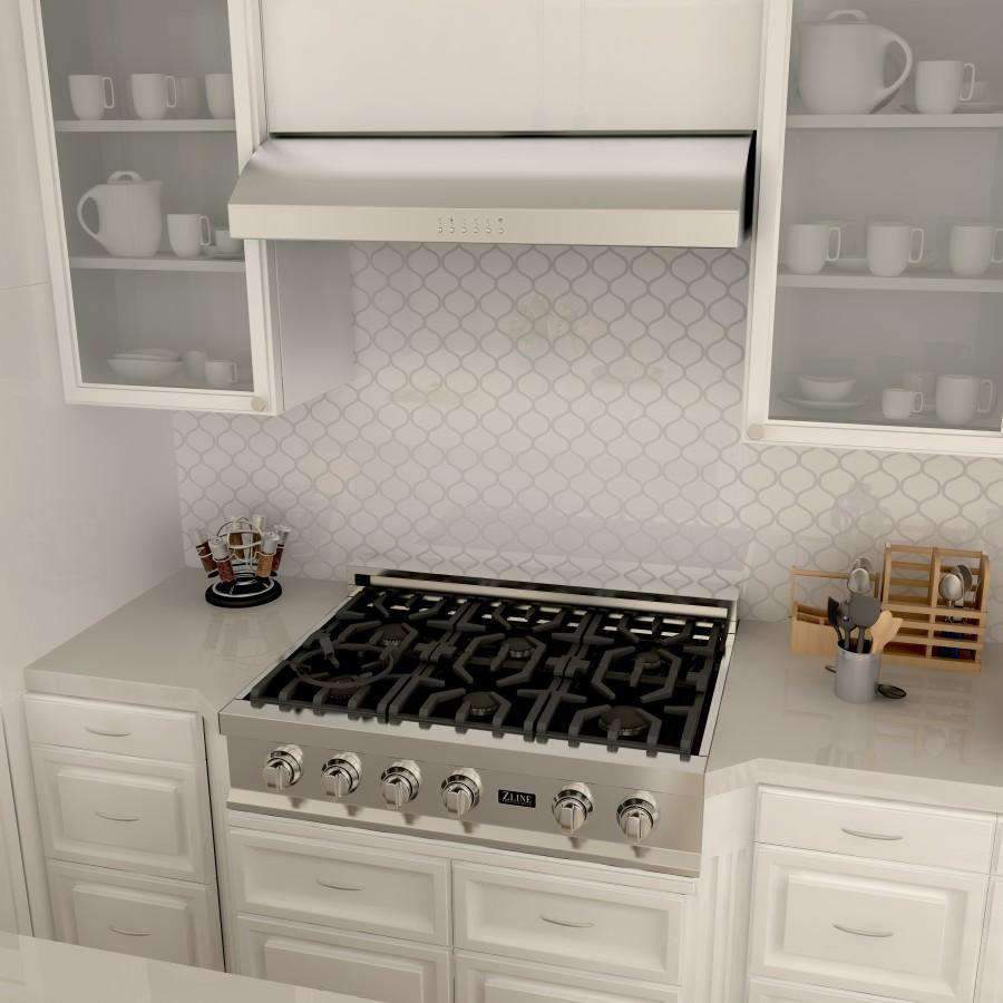 Stainless steel under-cabinet range hood above the cooktop with vent grille