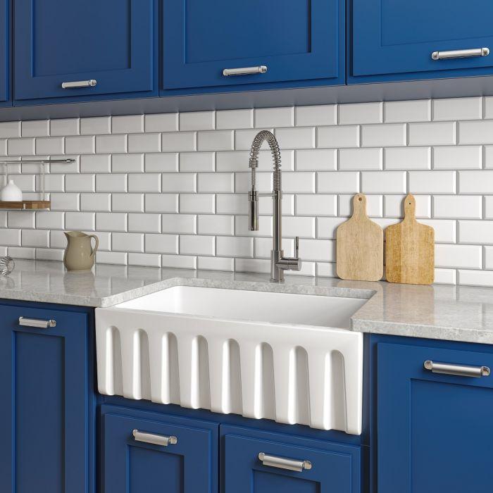 White apron-front single-bowl fireclay sink with ridged apron front