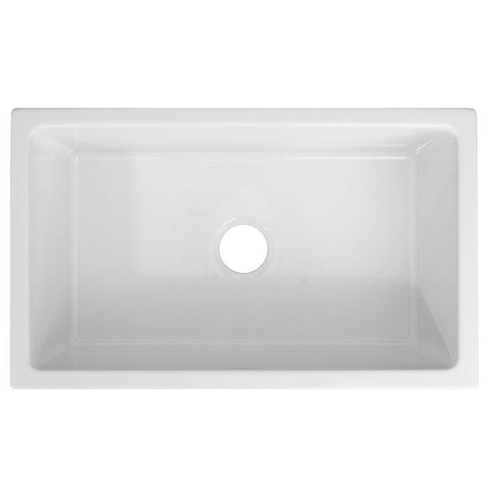 White rectangular farmhouse sink basin with centered drain opening