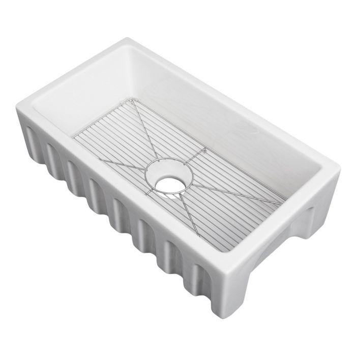 White apron-front single-bowl fireclay sink with bottom grid