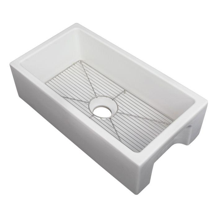White matte apron-front fireclay kitchen sink with bottom grid and centered drain opening