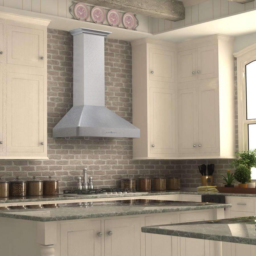 Satin stainless wall mount range hood with crown molding over a cooktop
