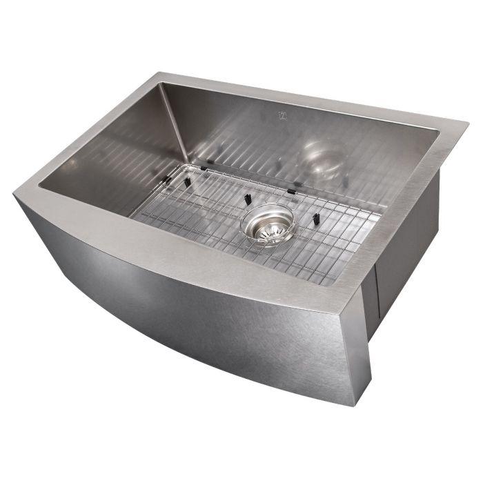 Single-bowl stainless apron sink with bottom grid, drain, and angled basin