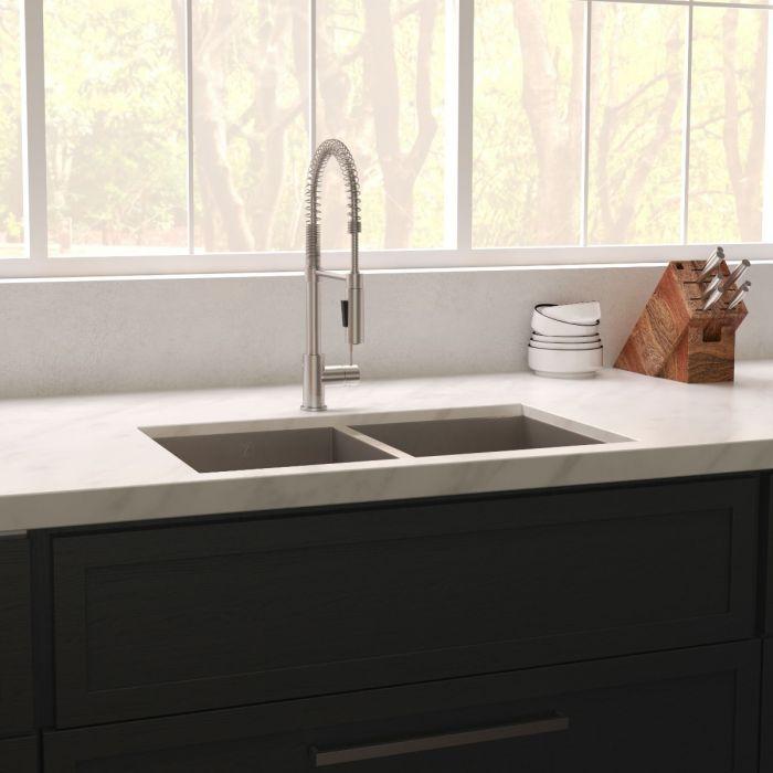Stainless steel double-bowl undermount kitchen sink installed in a modern kitchen with faucet