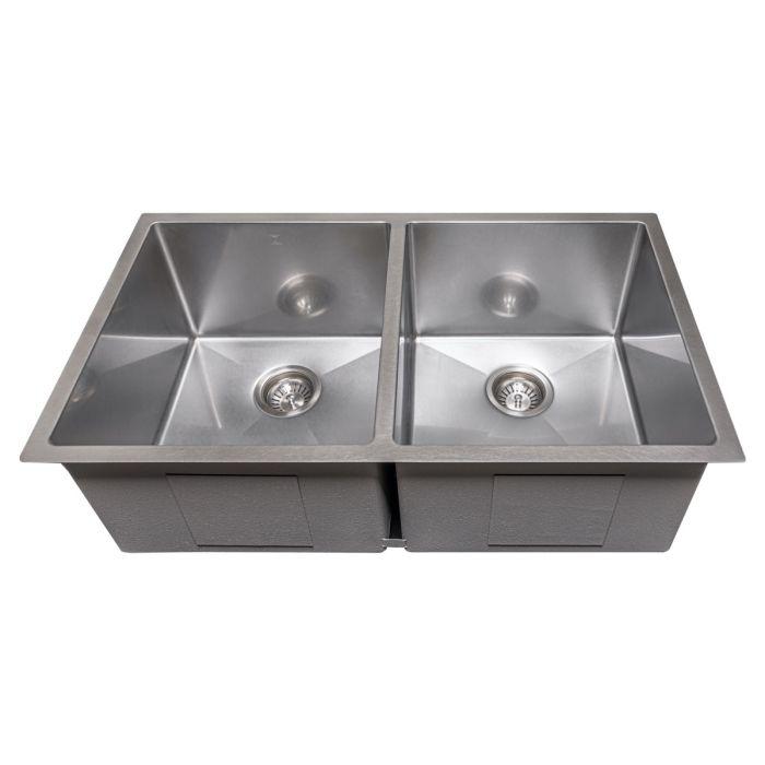 Stainless steel double-bowl undermount sink with two circular drain strainers, angled top view