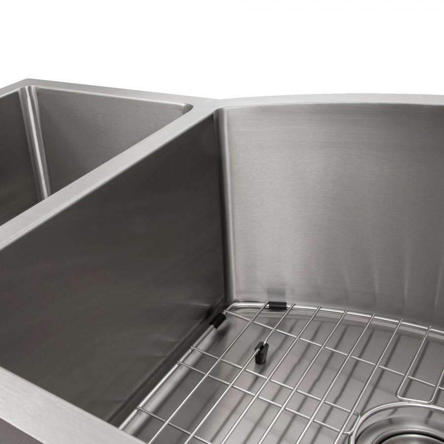 Stainless steel kitchen sink basin with installed wire bottom grid and side rails