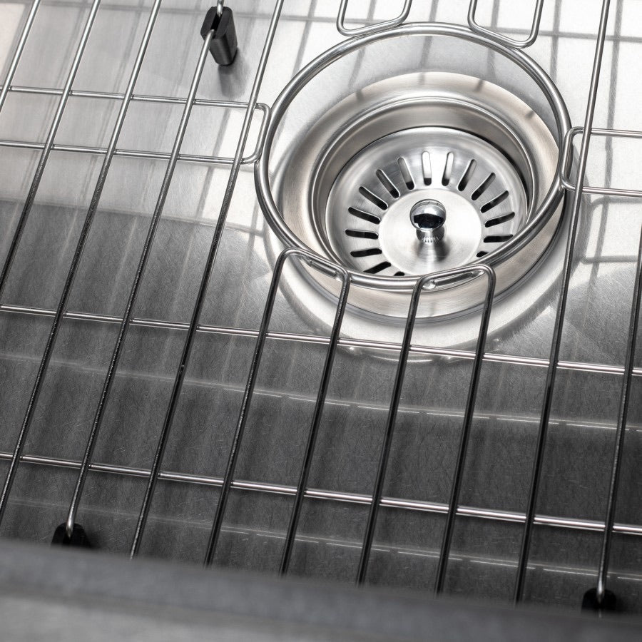 Stainless steel sink drain strainer with central grate and surrounding basin grid