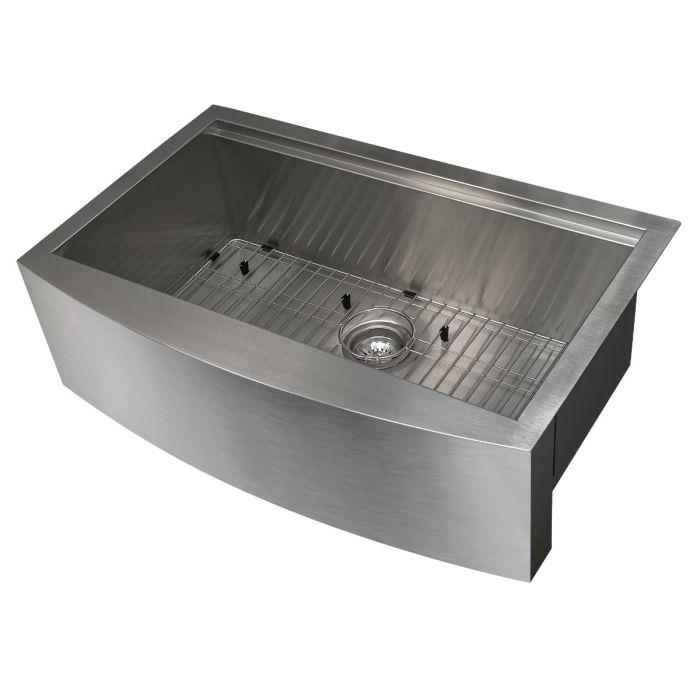 Apron-mount stainless steel single-bowl sink with bottom grid and drain strainer, angled view