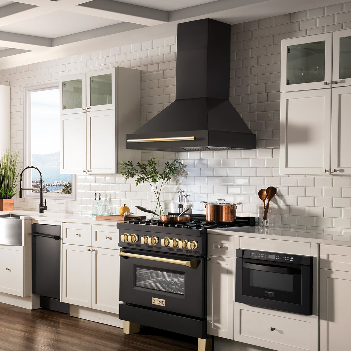 Black wall-mount range hood with gold trim above cooktop