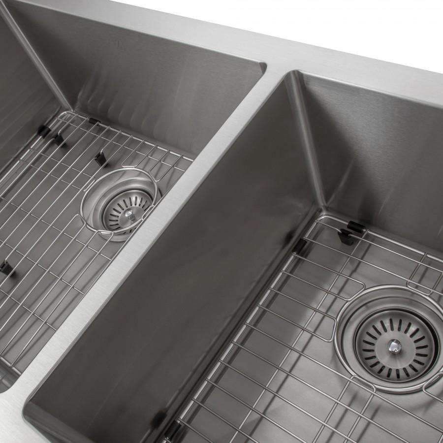 Close-up of stainless steel double-basin sink with wire rack and circular drain strainers.