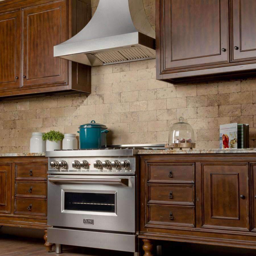 Satin stainless steel chimney-style wall range hood above cooktop