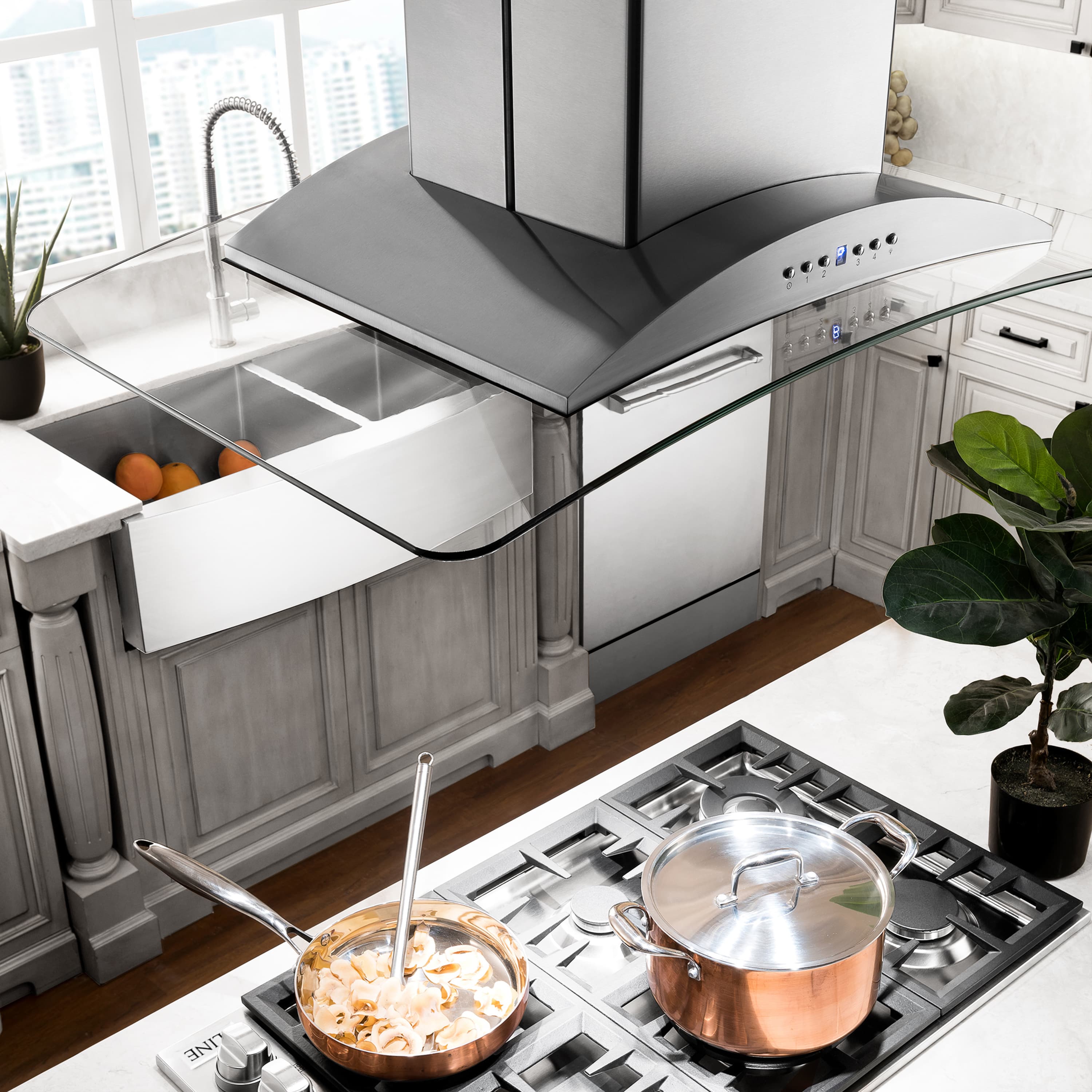 Island mount range hood over a kitchen cooktop, stainless steel chimney and hood