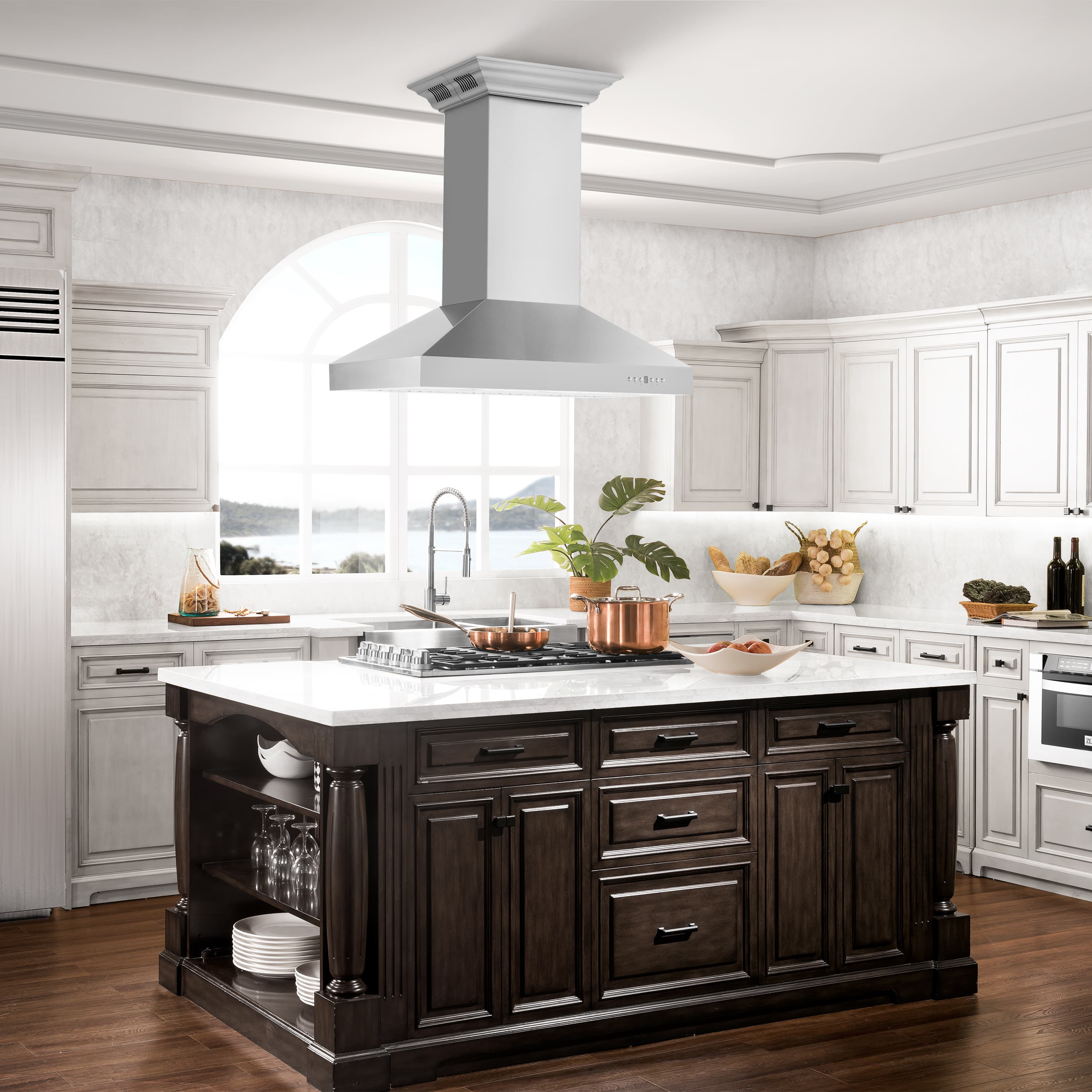 Stainless steel ducted island range hood over kitchen island with central chimney