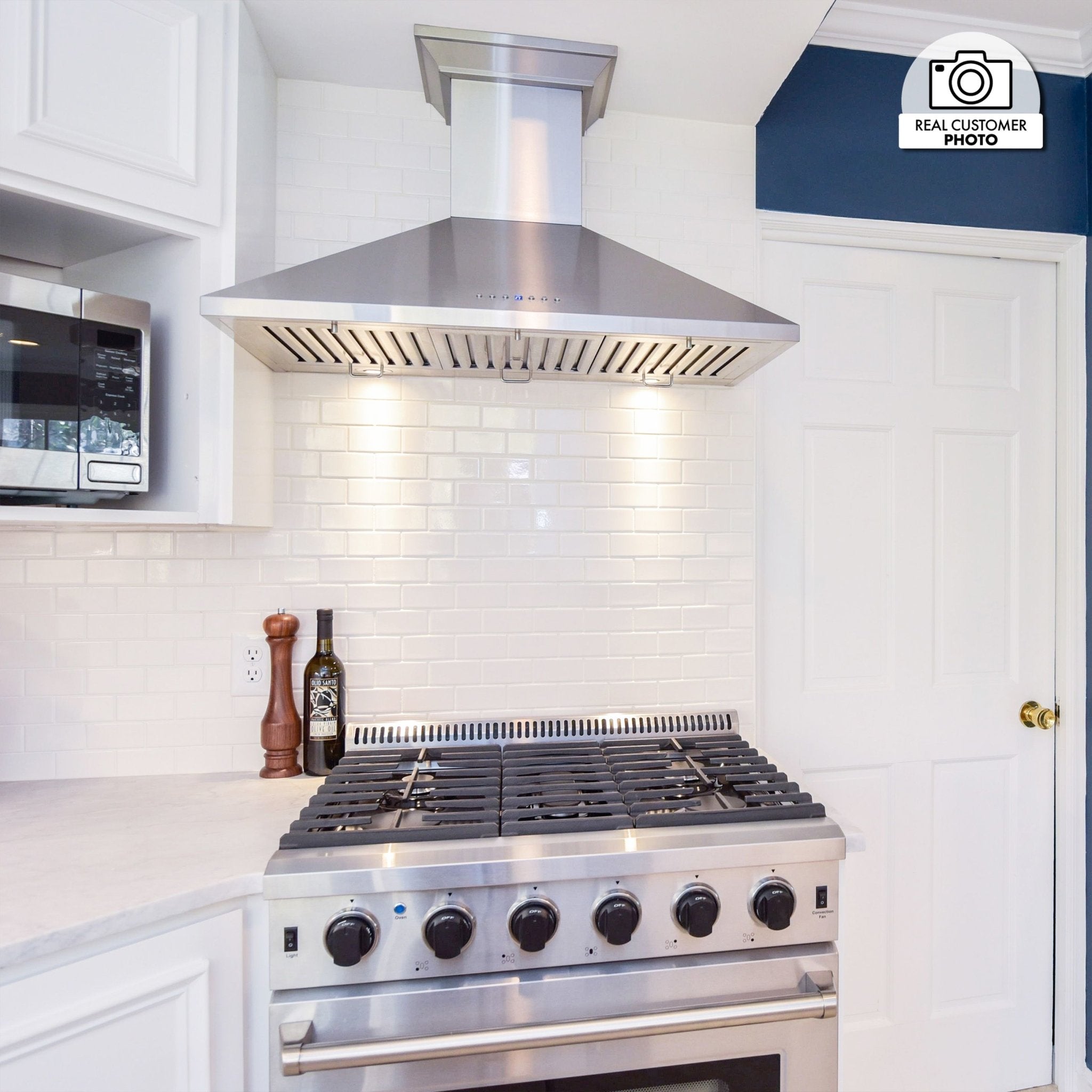 Stainless steel convertible wall range hood with vent slots and chimney