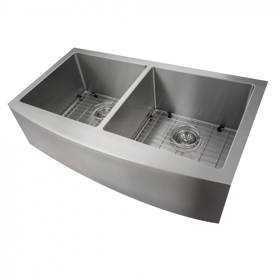 Angled view of stainless steel double-bowl apron sink with wire bottom grids and drains