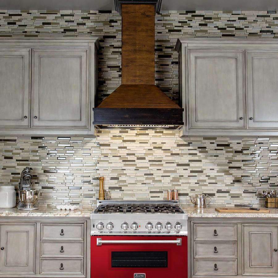 Stainless dual fuel range with red-gloss oven door centered in a tiled kitchen
