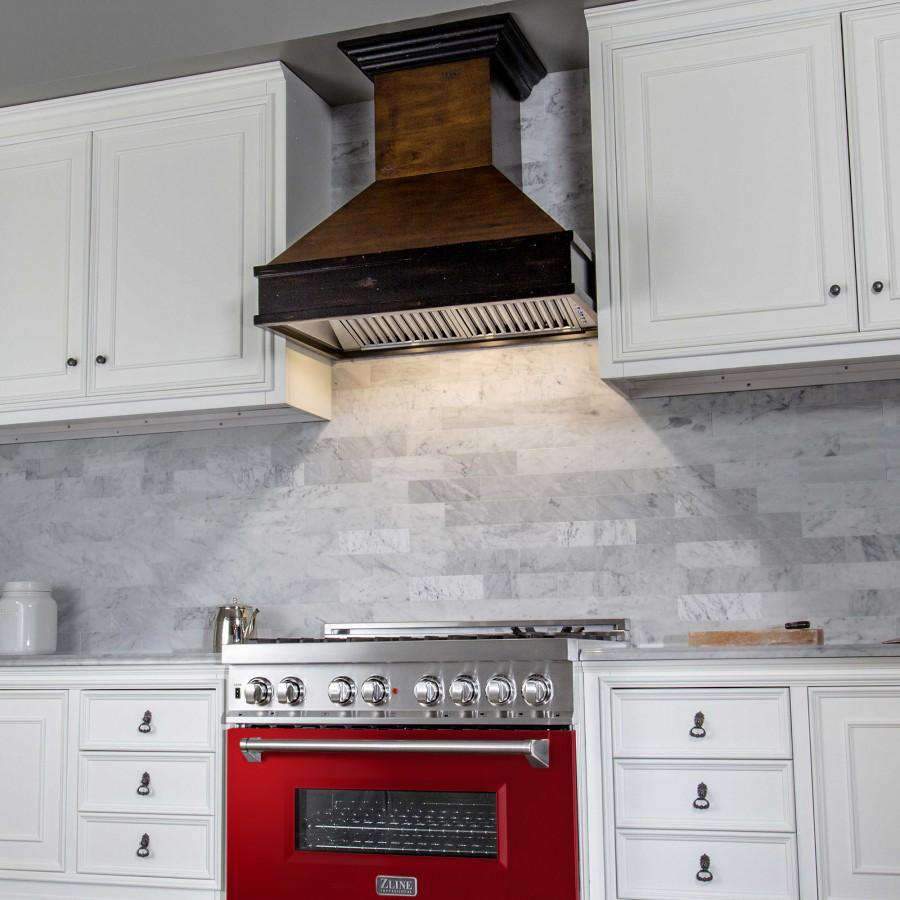 Under-hood view of stainless dual fuel range with red-gloss oven door