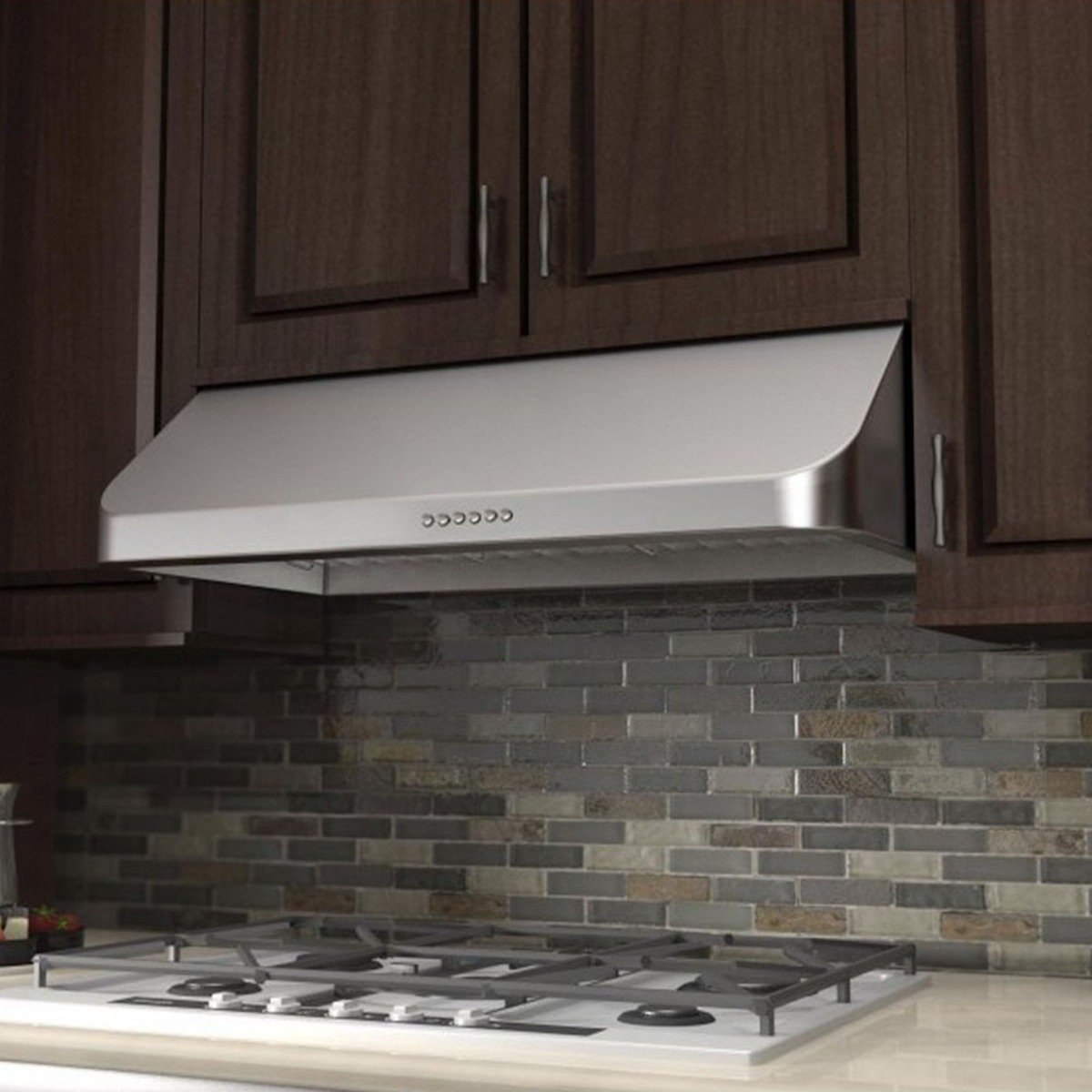 Stainless steel under-cabinet range hood over gas cooktop with angled canopy