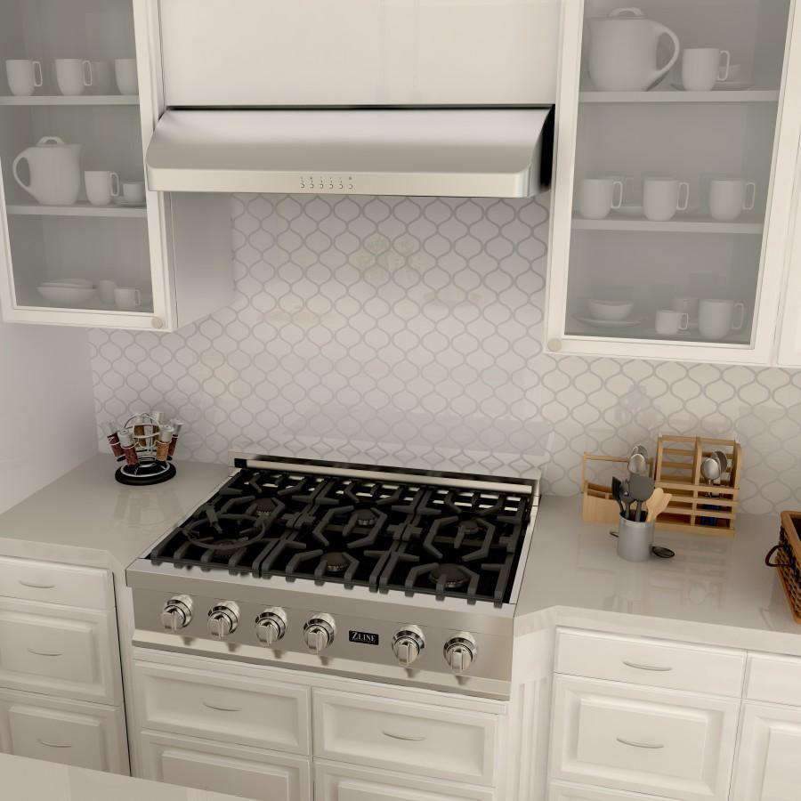 Stainless steel under-cabinet range hood over gas cooktop with underside filter panels
