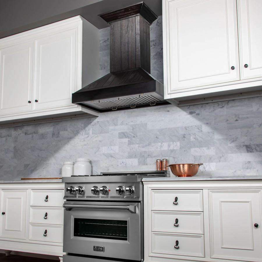 Dark wooden wall range hood chimney above a stainless stove with knobs