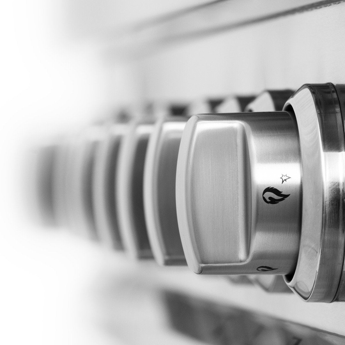 Stainless control knobs with burner icons on a dual-fuel range