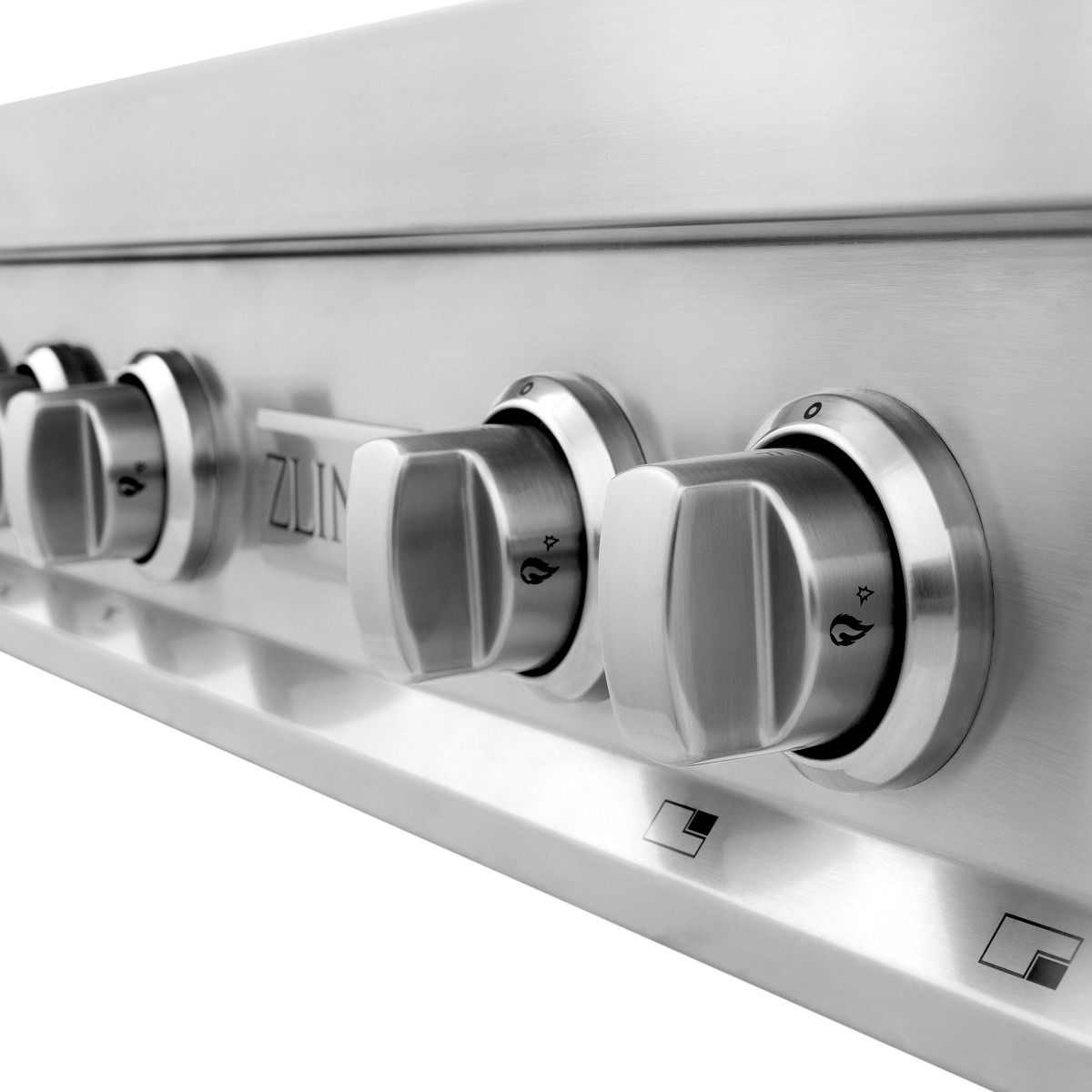 Close-up of stainless steel rangetop control knobs with burner markings